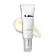 Een witte tube Advanced Day Ultimate Protect staat rechtop, met daarnaast een veeg lichte crème die de textuur van het product laat zien.